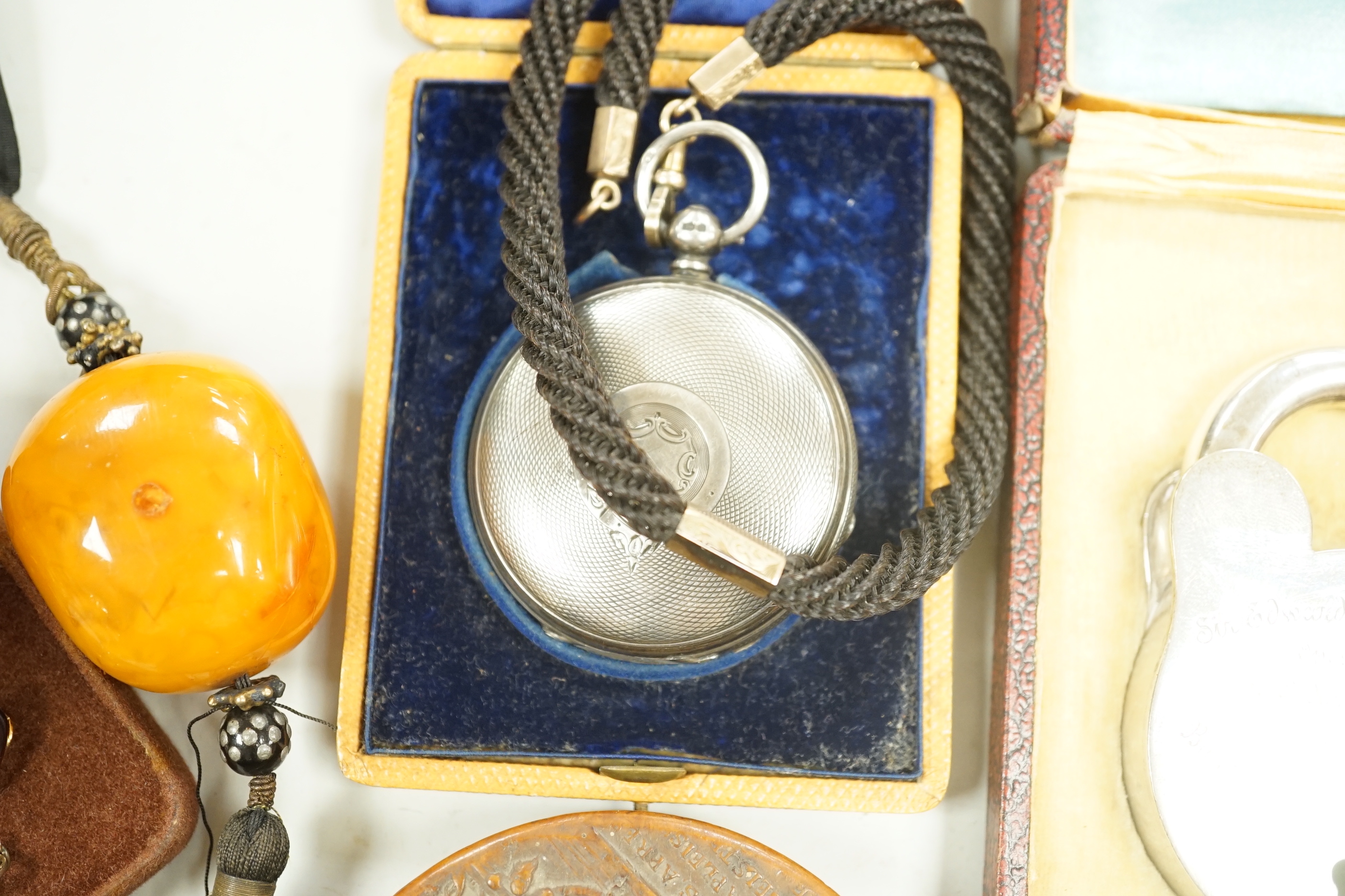 A group of 19th century and later collectibles to include a silver plated presentation padlock and key, a silver hunter pocket watch, french snuff box, etc.